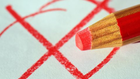 Illustrative photo: pen, red pen, mark with a cross