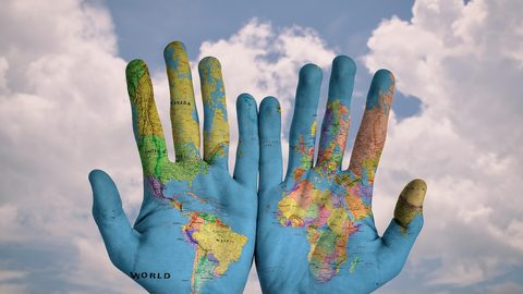 Illustrative photo: hands, world, map